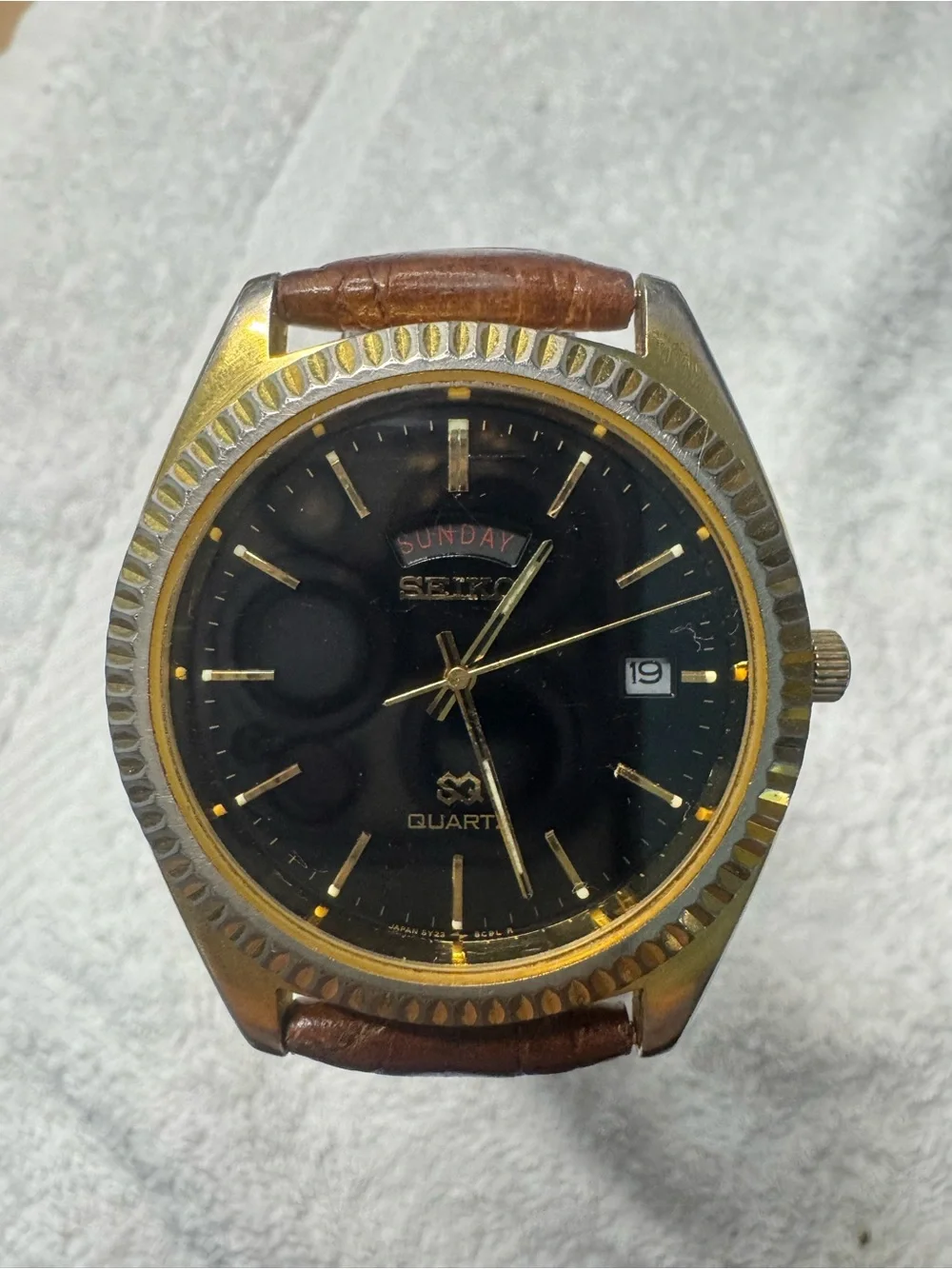 Seiko Black Dial Watch with Gold Accents and Brown Leather Strap